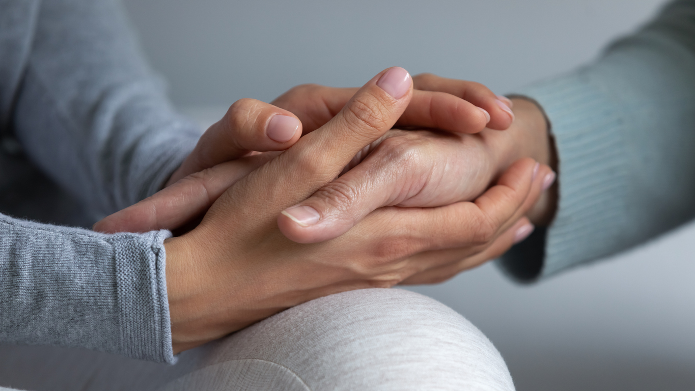 rn care manager holding patient's hand
